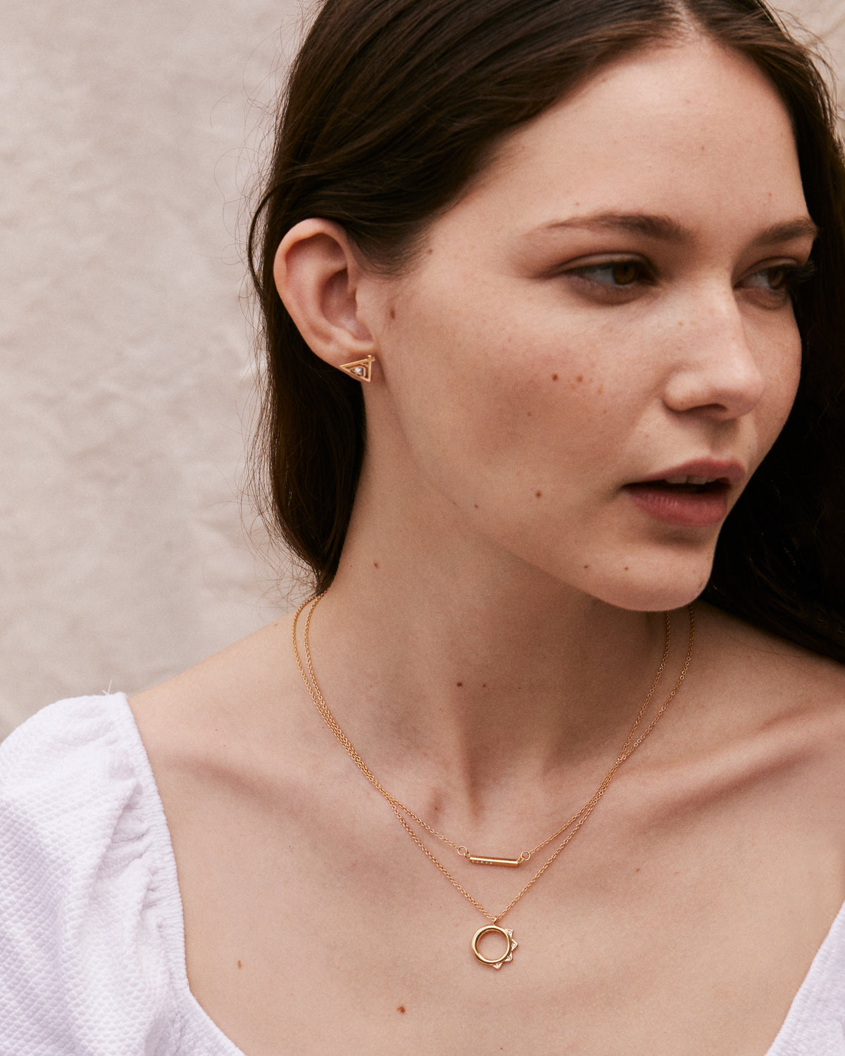 Model wearing Blank Slate Necklace, Squad Necklace, and Tribe Earrings in Gold