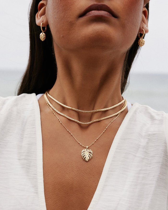 Close-up of model wearing depth necklace and earrings