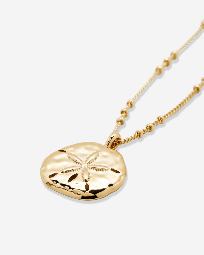 Sea Seeker Sand Dollar Pendant Necklace in Gold Close Up Product Photography