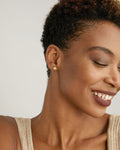 Model wearing Stars Can't Shine Without Darkness Earrings in 14k gold finish