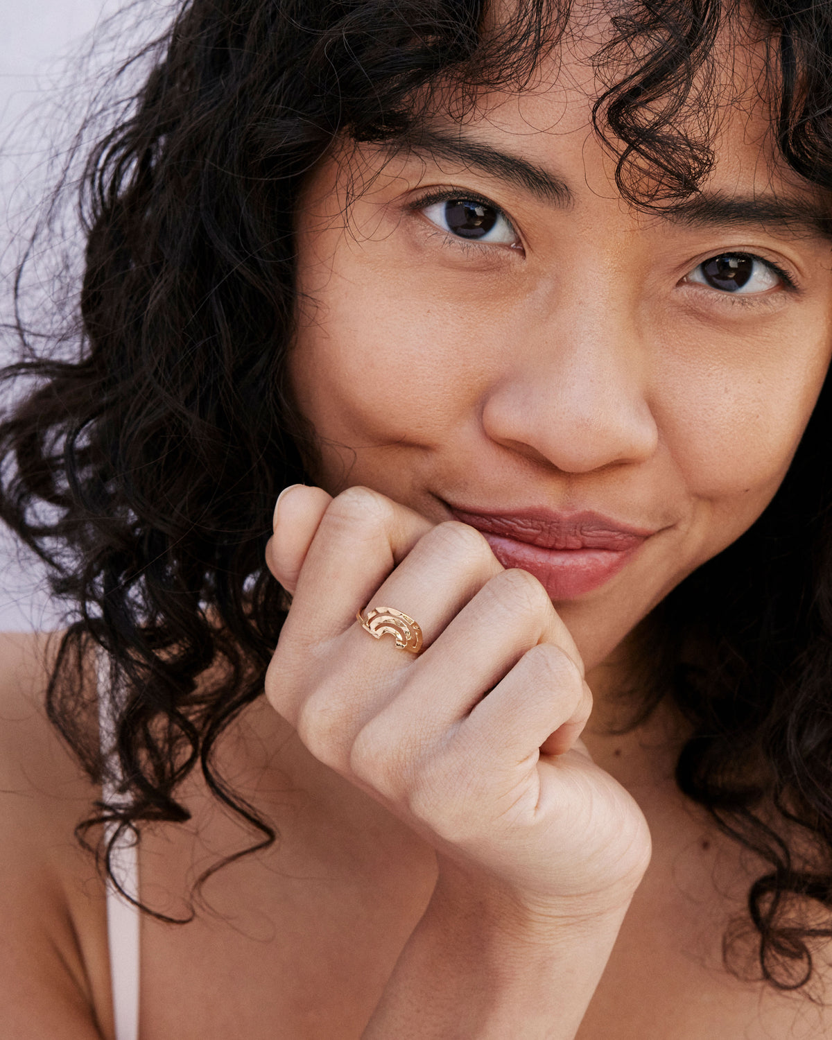 Model wearing Overcome Ring in 14k gold finish