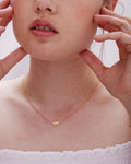 Model wearing Rise Necklace in 14k gold finish