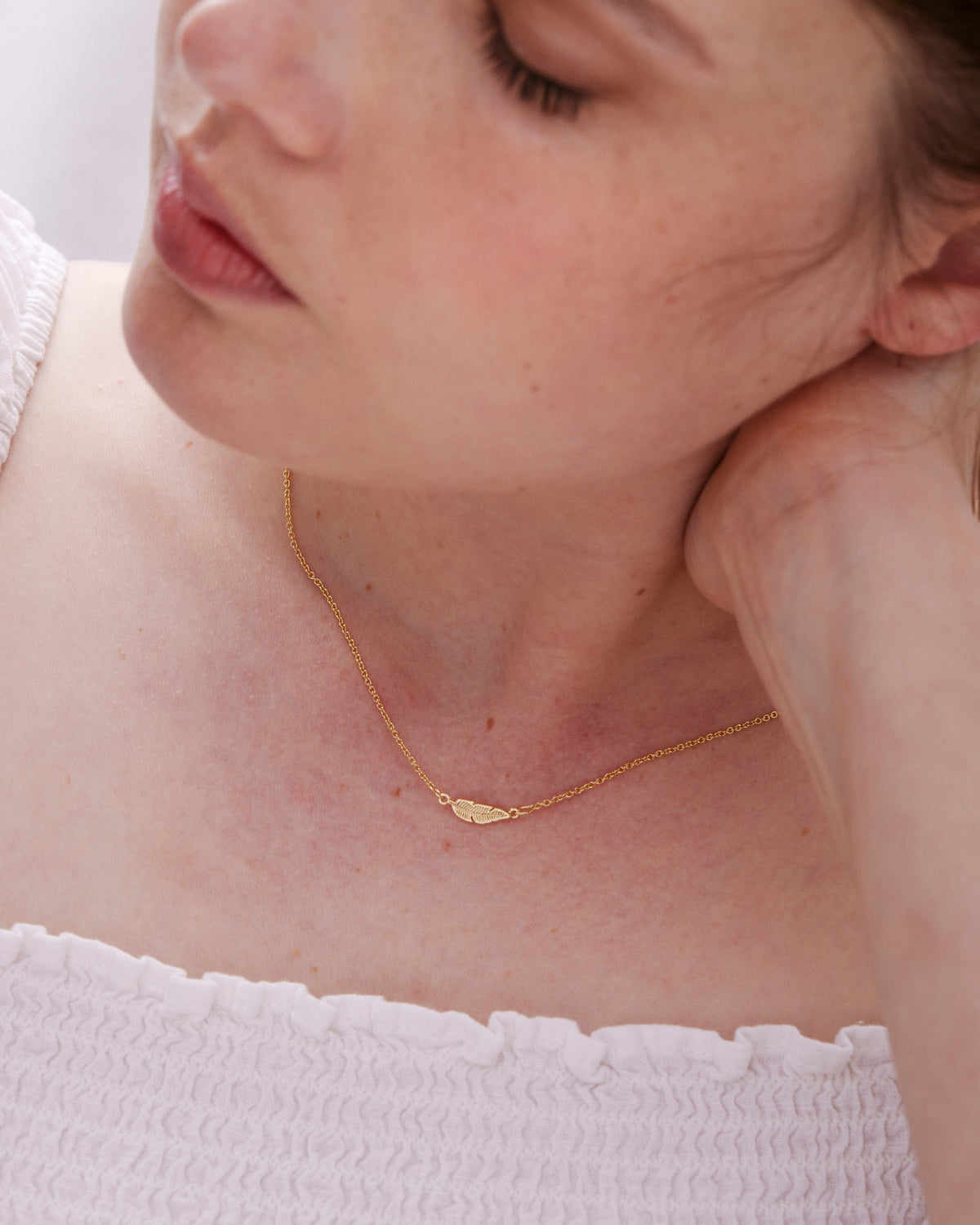 Model wearing Rise Necklace in rose gold finish
