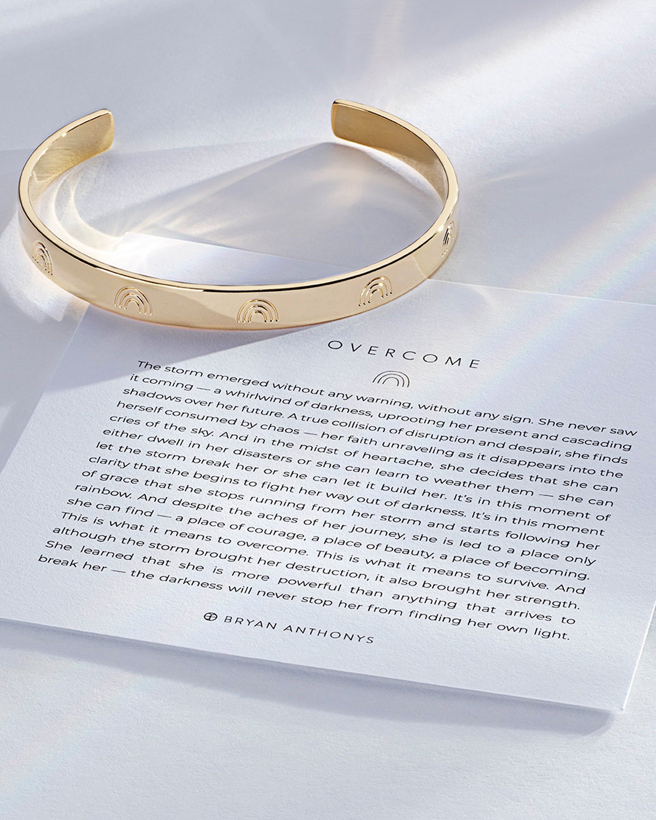 Overcome Engraved Cuff showcase in 14k gold on card