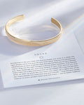 Squad Engraved Cuff showcase in 14k gold on card