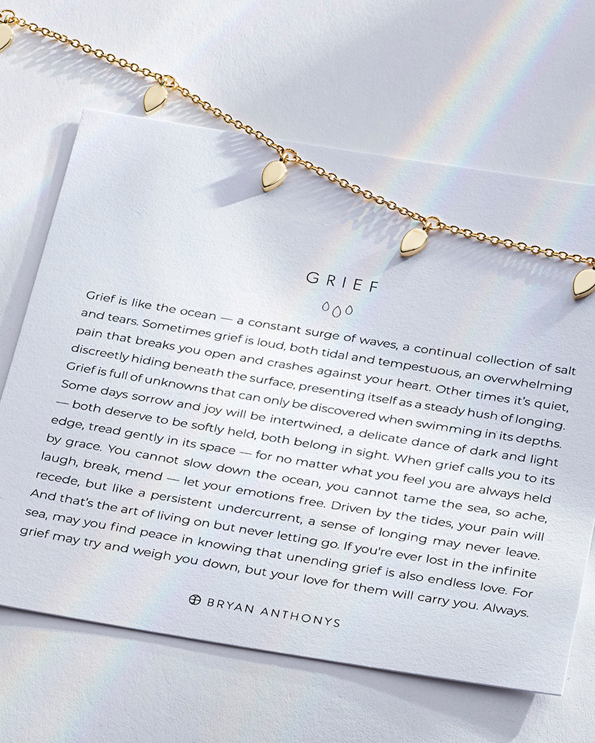 Grief Necklace showcase in 14k gold on card