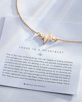 There In A Heartbeat Necklace showcase in 14k gold on card